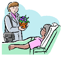 woman with flowers visiting person in hospital bed
