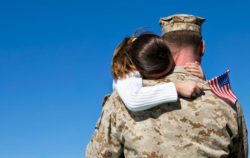 military servicemember hugs daughter