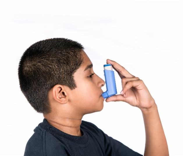 Young boy with asthma inhaler