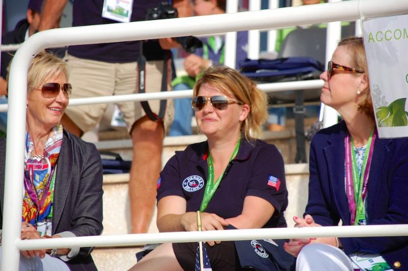 USEF president Chrystine Tauber (left) and USET Foundation executive director Bonnie Jenkins (right) take in WEG para-dressage freestyles with 2014 U.S. WEG competitor Susan Treabess. CREDIT: Jennifer Bryant